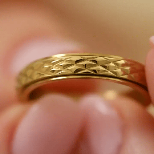 gold spinning cross pattern ring